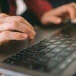Person using a keyboard while testing an accessible website