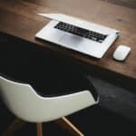Introducing Altus Workspace: Business Tools, AI and Marketing Services in One Place 1 Laptop and mouse on a wooden desk in a modern workspace