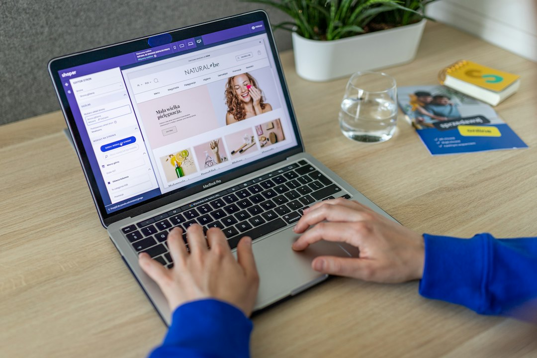 Digital Consulting Pros - Digital Marketing Agency Malta 11 Business owner reviewing an ecommerce store design on a laptop