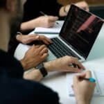 Meet Prospekta: AI Marketing and Sales Tools to Grow Your Business 2 Business team collaborating around a laptop during a planning meeting