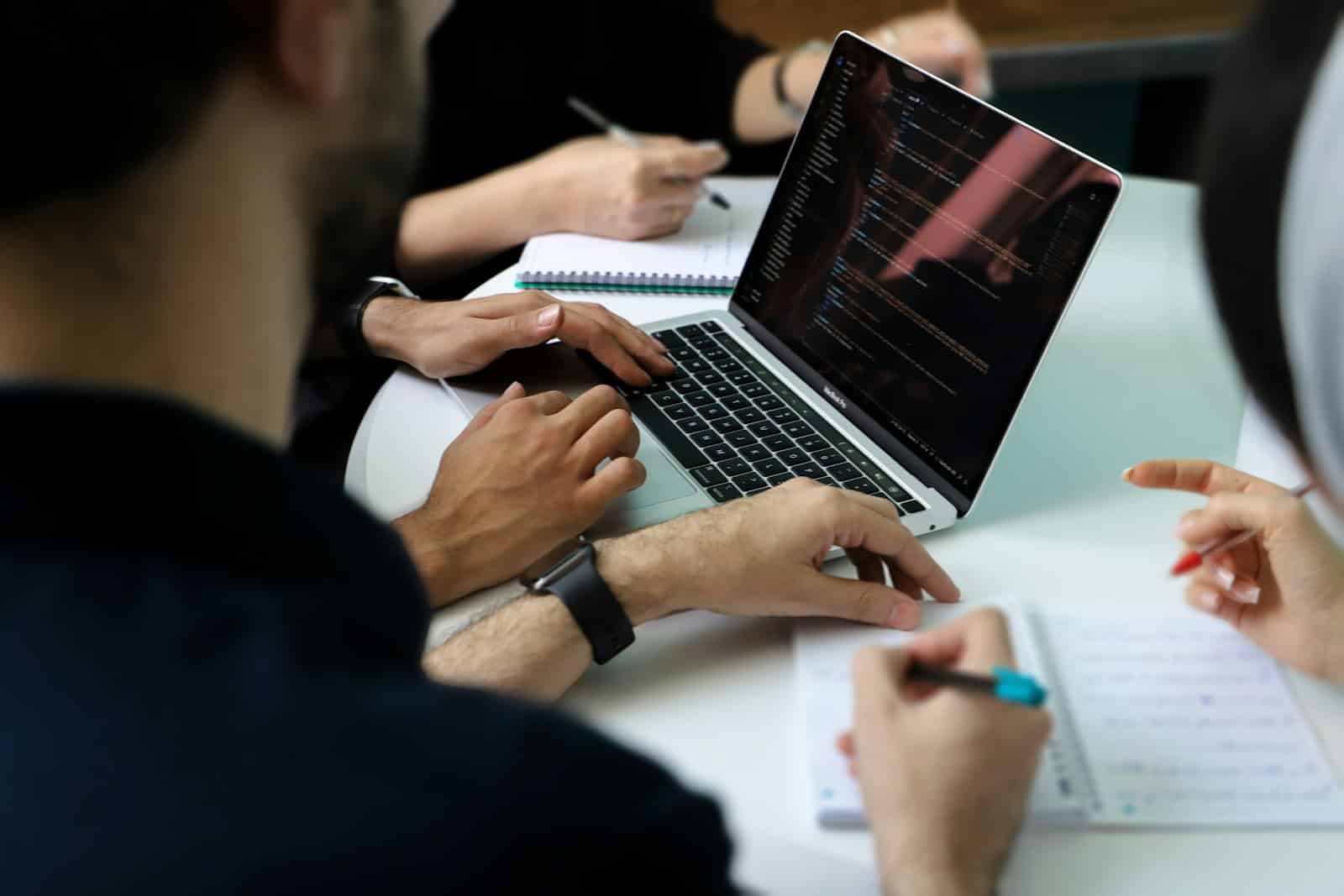 Business team collaborating around a laptop during a planning meeting