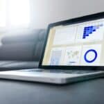 Website Integration Checklist for Malta Businesses 1 Laptop displaying business data beside a notebook, representing connected website systems