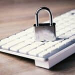 Padlock resting on a computer keyboard, representing website privacy and data protection